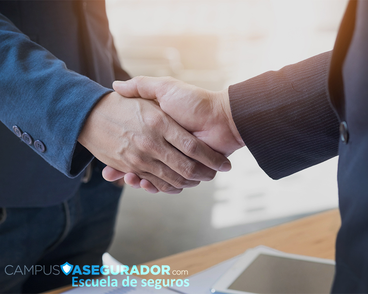 Apretón de manos entre profesionales con logo de Campus Asegurador en entorno de oficina y formación en seguros.