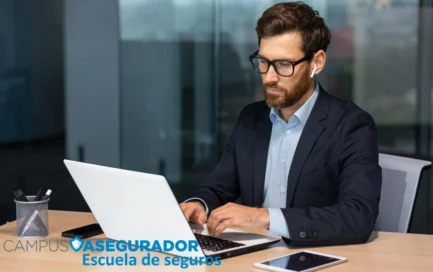 Profesional sector seguros trabajando con portátil y auriculares. Logotipo de Campus Asegurador en la zona inferior.